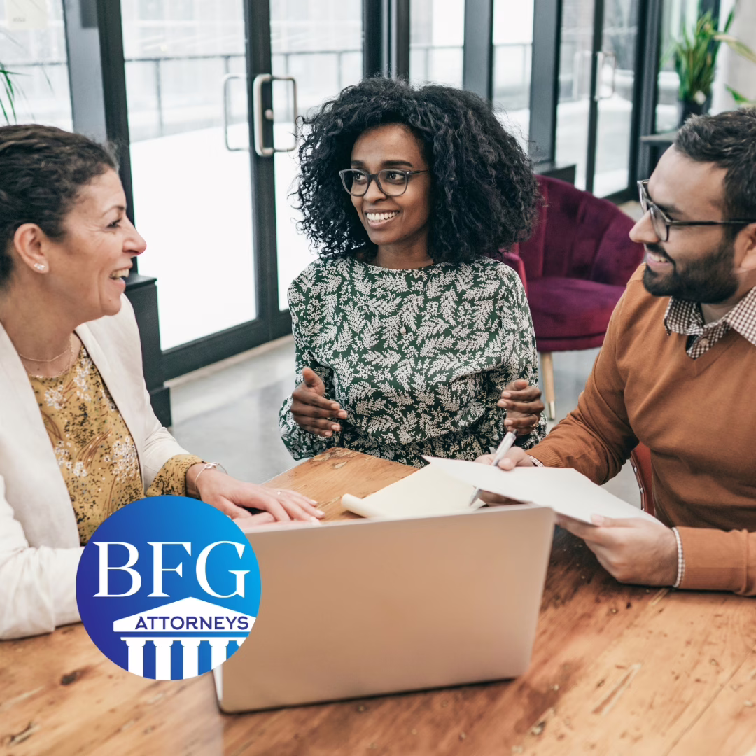 A couple meeting with an estate planning attorney and the Bangerter Frazier Group logo